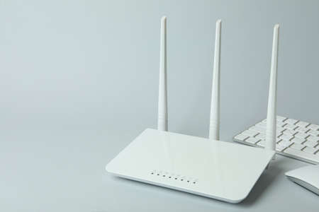 Workplace with Wi - fi router on gray background