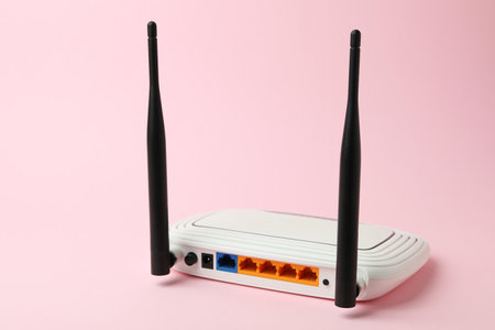 Wi-Fi router with external antennas on pink backgroundの写真素材