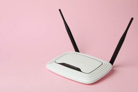 Wi-Fi router with external antennas on pink backgroundの写真素材