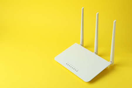 Wi-Fi router with external antennas on yellow backgroundの写真素材