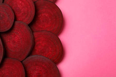 Chopped ripe red beet on pink backgroundの写真素材
