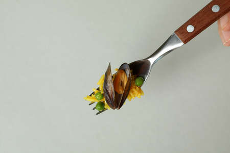 Fork with Spanish Paella on gray background