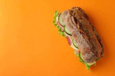 Sandwich of ciabatta bread on orange backgroundの写真素材