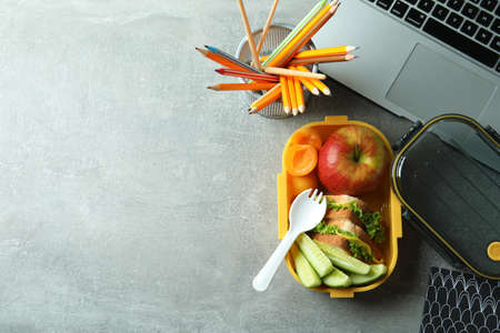 Study concept with lunch box on gray textured tableの写真素材