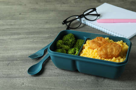 Workplace with lunch box on gray textured tableの写真素材
