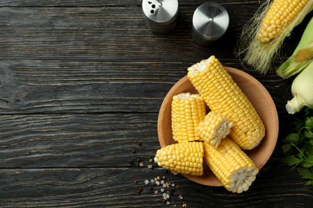Fresh raw corn, parsley and spices on wooden tableの写真素材