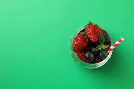 Glass with smoothie ingredients on green backgroundの写真素材