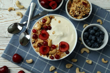 Concept of tasty breakfast with yogurt on wooden tableの写真素材