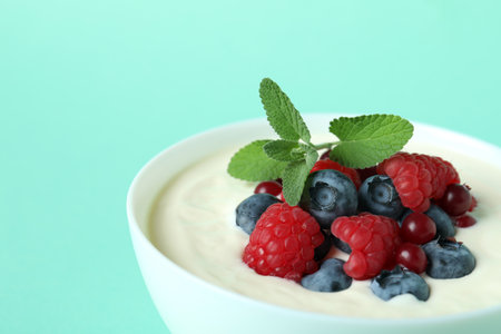 Concept of tasty breakfast with yogurt on mint backgroundの写真素材