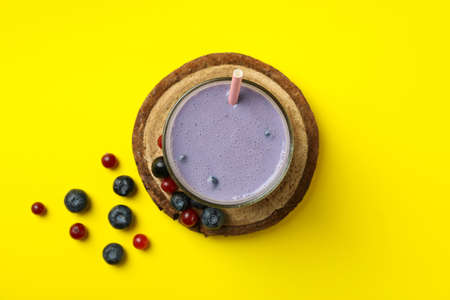 Fresh blueberry smoothie and ingredients on yellow backgroundの写真素材
