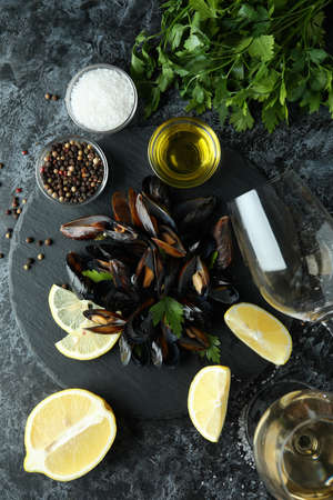 Concept of delicious food with mussels on black smokey tableの写真素材