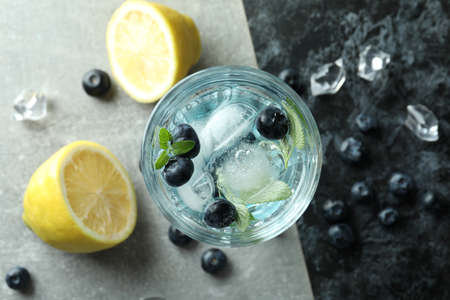 Glass of summer cocktail and ingredients on two tone backgroundの写真素材
