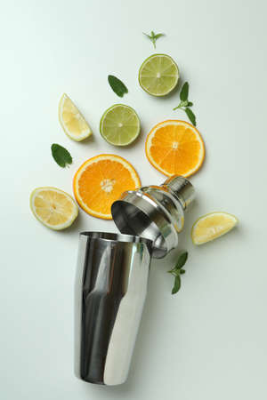 Shaker with citrus cocktail ingredients on white backgroundの写真素材