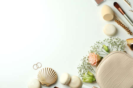 Female accessories and macaroons on white background