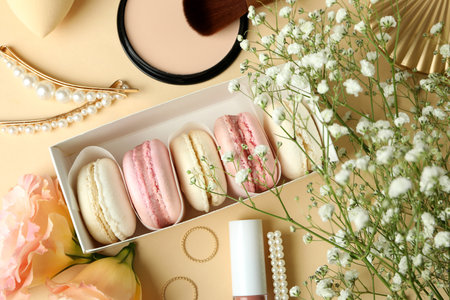 Female accessories and macaroons on beige backgroundの写真素材