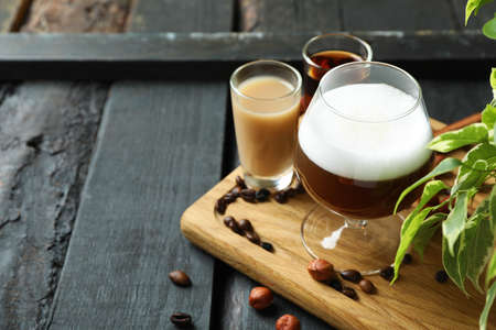 Concept of delicious drink with Irish coffee on wooden board
