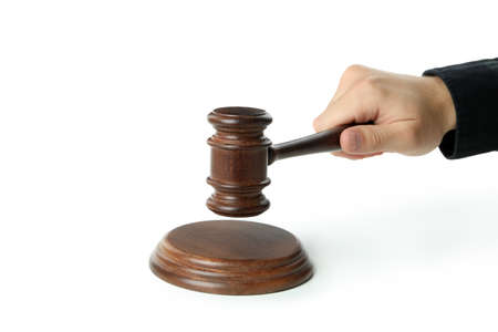Male hand holds judge gavel, isolated on white backgroundの写真素材