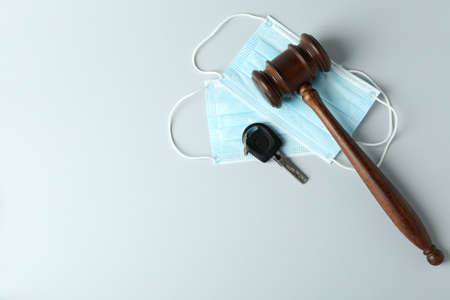 Judge gavel, key and medical masks on white background