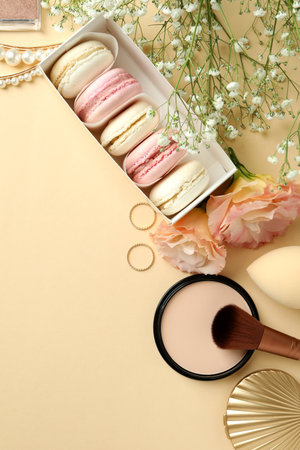 Female accessories and macaroons on beige backgroundの写真素材