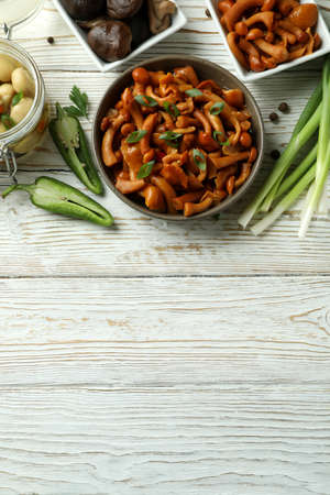 Concept of tasty food with marinated mushrooms on wooden tableの写真素材