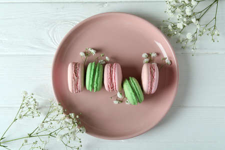 Concept of tasty dessert with macaroons on white wooden backgroundの写真素材