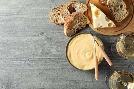 Concept of delicious food with fondue on gray textured tableの写真素材