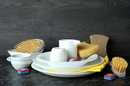 Concept of Dishwashing detergent accessories on black smokey tableの写真素材