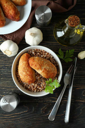 Concept of tasty food with cutlets on wooden table