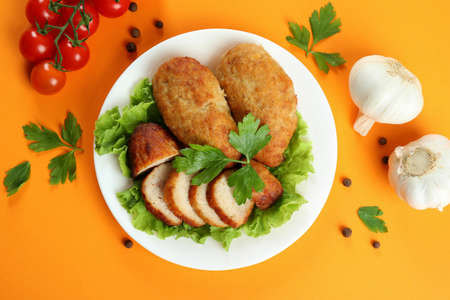 Concept of tasty food with cutlets on orange backgroundの写真素材