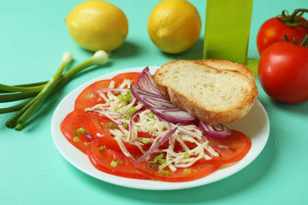 Concept of tasty food with tomato carpaccio on mint backgroundの写真素材
