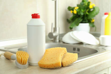 Concept of Dishwashing detergent accessories on kitchen background