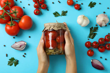 Concept of pickled vegetables with tomatoes on blue backgroundの写真素材