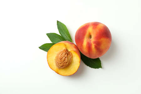 Ripe peach fruits with leaves on white backgroundの写真素材