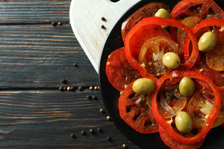 Concept of tasty food with tomato carpaccio on rustic wooden tableの写真素材