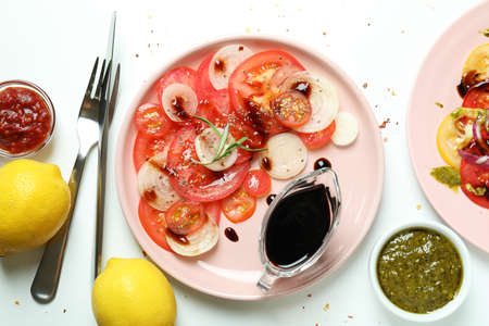 Concept of tasty food with tomato carpaccio on white backgroundの写真素材