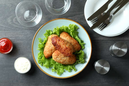 Concept of tasty food with cutlets on dark wooden tableの写真素材