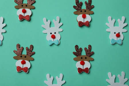 Decorative Christmas deers with glitter on mint background