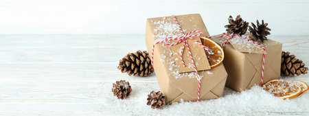 Gift boxes and Christmas accessories on white wooden table