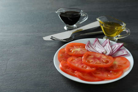 Concept of tasty food with tomato carpaccio on dark tableの写真素材