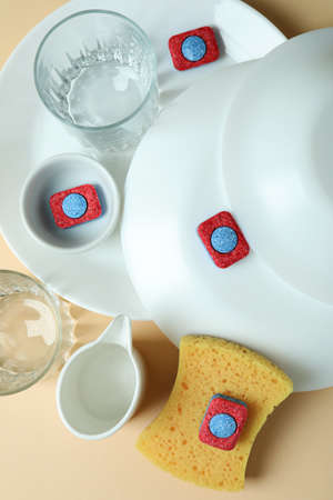 Concept of Dishwashing detergent accessories on beige background