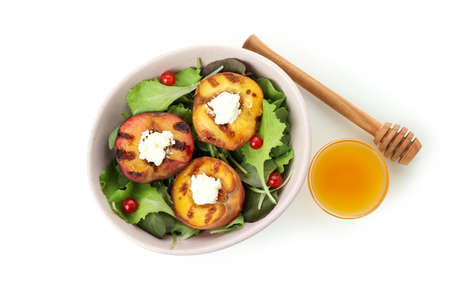 Salad with grilled peach isolated on white backgroundの写真素材