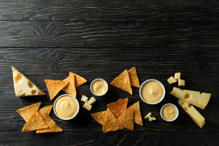 Cheese sauce, cheese and chips on rustic wooden tableの写真素材