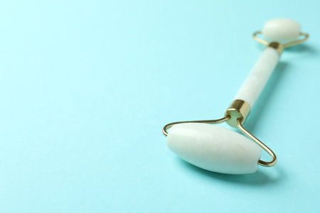 White face massage roller on blue backgroundの写真素材