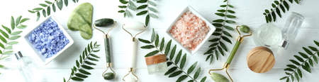 Skin care concept with face rollers on white wooden backgroundの写真素材
