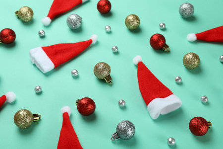 Santa hats and baubles on mint backgroundの写真素材