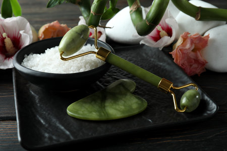 Skin care concept with face roller on wooden tableの写真素材