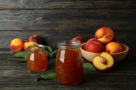 Peach jam and ingredients on rustic wooden tableの写真素材
