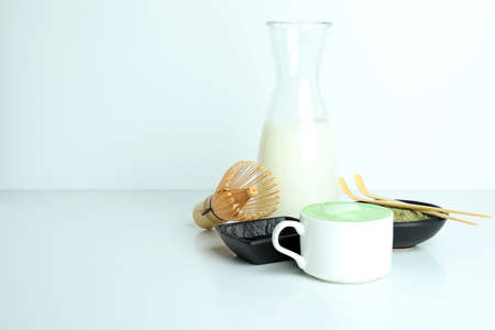 Matcha latte and accessories for making on white tableの写真素材