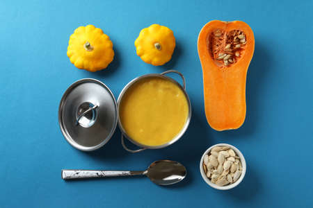 Concept of tasty food with pumpkin soup on blue backgroundの写真素材