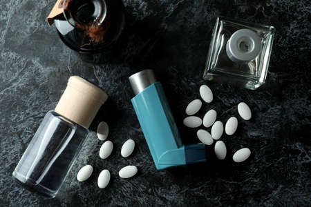 Asthma treatment accessories on black smokey tableの写真素材